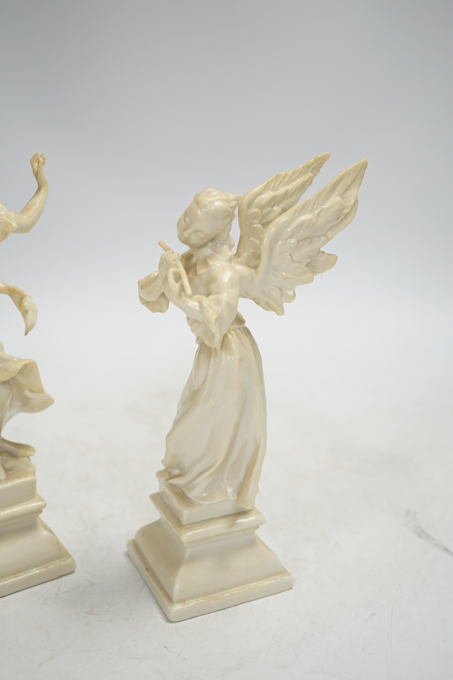 A pair of Nymphenburg white glazed figures of angels, tallest 18.5cm high. Condition - grubby, otherwise good